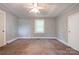 Cozy bedroom with ceiling fan, window, closet door, neutral carpet and trim at 1529 Stony Point Rd, Shelby, NC 28150