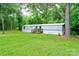 Exterior view of a house featuring lawn, mature trees, a deck, and stairs at 1529 Stony Point Rd, Shelby, NC 28150