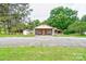 Charming single-story home with a covered front porch and neutral-colored siding, nestled among mature trees at 1529 Stony Point Rd, Shelby, NC 28150