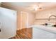 Cozy kitchen with white appliances, laminate flooring, and view of sink and cabinets at 1529 Stony Point Rd, Shelby, NC 28150