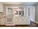 White appliances and cabinets in the kitchen, laminate flooring, and connecting rooms and ample storage at 1529 Stony Point Rd, Shelby, NC 28150