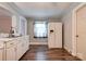 Classic kitchen with laminate flooring, white appliances, cabinets, and sink, with a window over the sink at 1529 Stony Point Rd, Shelby, NC 28150