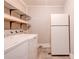 Well lit laundry room with modern washer, dryer and open shelving at 1529 Stony Point Rd, Shelby, NC 28150