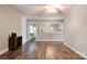 View of a bright, cozy living area featuring hardwood floors and a glimpse into the adjoining kitchen at 1529 Stony Point Rd, Shelby, NC 28150