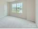 Cozy bedroom with neutral carpet and a large window offering natural light at 1543 Cottage Creek Dr, Bessemer City, NC 28016