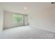 Bright bedroom with neutral carpet, a large window, and a closet for storage at 1543 Cottage Creek Dr, Bessemer City, NC 28016