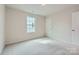 Bright bedroom featuring a window and neutral carpeting perfect for relaxation and personalization at 1543 Cottage Creek Dr, Bessemer City, NC 28016