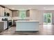 Modern kitchen featuring stainless steel appliances, a center island, and access to the backyard at 1543 Cottage Creek Dr, Bessemer City, NC 28016