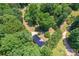 Aerial view of a home nestled among lush trees and mature landscaping at 1773 Baldwin Ln, Lincolnton, NC 28092