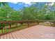 Wooden deck with railing overlooking backyard and lush green trees at 1773 Baldwin Ln, Lincolnton, NC 28092