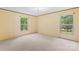 Bedroom showcasing neutral walls and plush carpeting, with ample light from the double-hung windows at 1773 Baldwin Ln, Lincolnton, NC 28092