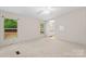 A bright bedroom with neutral walls, plush carpeting, and a double-hung window overlooking the lush landscape at 1773 Baldwin Ln, Lincolnton, NC 28092