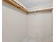An empty walk-in closet with wall paneling, neutral carpet flooring, and white shelving at 1773 Baldwin Ln, Lincolnton, NC 28092