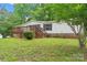 Charming single-story home featuring a wooden deck and lush greenery surrounding the property at 1773 Baldwin Ln, Lincolnton, NC 28092