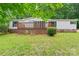 Inviting exterior view with a cozy wooden deck and well-maintained landscaping at 1773 Baldwin Ln, Lincolnton, NC 28092