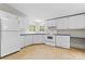 Well-lit kitchen featuring white cabinets and appliances, with a neutral tile floor at 1773 Baldwin Ln, Lincolnton, NC 28092