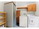 Laundry room with washer, dryer, cabinetry, shelving, and blue tile flooring at 1773 Baldwin Ln, Lincolnton, NC 28092