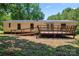 Back of home featuring a large deck with ramp and french doors leading into home at 1773 Baldwin Ln, Lincolnton, NC 28092