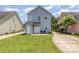 A blue house with a well-maintained backyard, patio area, and green lawn, ideal for outdoor activities at 1825 Stroud Park Ct, Charlotte, NC 28206