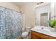 A well-lit bathroom with a shower, toilet, vanity, and a decorative plant, offering a clean and functional space at 1825 Stroud Park Ct, Charlotte, NC 28206