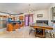 Open concept kitchen and dining room with island and a dark wood table at 1825 Stroud Park Ct, Charlotte, NC 28206