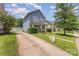 A well-maintained home is showcased with its lush green lawn and concrete driveway at 1825 Stroud Park Ct, Charlotte, NC 28206