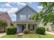 Charming two-story home featuring a cozy front porch and well-maintained landscaping at 1825 Stroud Park Ct, Charlotte, NC 28206
