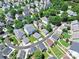 An aerial view showcasing the layout of homes in a residential neighborhood with lush greenery and private yards at 187 Water Oak Dr, Mooresville, NC 28117