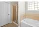 Bathroom featuring a bathtub, glass-door shower, and tiled accents at 187 Water Oak Dr, Mooresville, NC 28117
