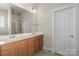 Bathroom featuring a double sink vanity with a large mirror and a glass enclosed shower at 187 Water Oak Dr, Mooresville, NC 28117