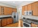 Functional kitchen featuring stainless steel appliances, wood cabinets, and granite countertops at 187 Water Oak Dr, Mooresville, NC 28117