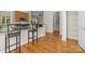 Kitchen featuring granite counters, stainless microwave, breakfast bar and hardwood floors at 187 Water Oak Dr, Mooresville, NC 28117