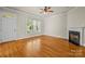 Bright living room with hardwood floors, fireplace, and large windows at 187 Water Oak Dr, Mooresville, NC 28117
