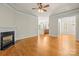 Open living room with hardwood floors, fireplace, and seamless transition to kitchen at 187 Water Oak Dr, Mooresville, NC 28117