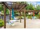 Community patio with wooden pergola providing shade over tables and chairs at 187 Water Oak Dr, Mooresville, NC 28117