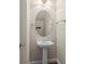 Charming powder room features a pedestal sink, decorative mirror and a towel rack at 187 Water Oak Dr, Mooresville, NC 28117