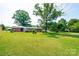 Spacious backyard showing mature trees, well-maintained lawn, and home exterior at 2309 13Th Street Ne Dr, Hickory, NC 28601