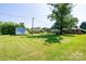 Spacious backyard featuring well-maintained lawn, storage shed, and mature trees at 2309 13Th Street Ne Dr, Hickory, NC 28601