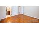 Bedroom view showcasing hardwood flooring, neutral paint and an adjacent bathroom at 2309 13Th Street Ne Dr, Hickory, NC 28601