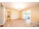Sun-filled dining room with tile floor and a sliding door to the enclosed sunroom at 2309 13Th Street Ne Dr, Hickory, NC 28601