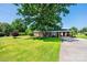 Charming brick home with large front yard and attached carport on a sunny day at 2309 13Th Street Ne Dr, Hickory, NC 28601