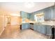Traditional eat-in kitchen with blue cabinets, neutral countertops, and stainless steel appliances at 2309 13Th Street Ne Dr, Hickory, NC 28601