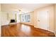 Bright living room features a ceiling fan, hardwood floors, a fireplace, and natural light at 2309 13Th Street Ne Dr, Hickory, NC 28601