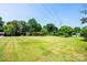 Expansive green lawn with mature trees offering shade on a sunny day at 2309 13Th Street Ne Dr, Hickory, NC 28601