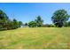 Wide-open green lawn with trees, showcasing landscaping possibilities at 2309 13Th Street Ne Dr, Hickory, NC 28601