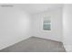 An empty bedroom with neutral carpet, blank walls, and a large window at 239 Paige Rd, Kings Mountain, NC 28086