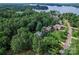 Scenic aerial view of a lakeside homes surrounded by lush trees and manicured lawns at 2541 Penngate Dr, Sherrills Ford, NC 28673