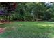 Expansive backyard with lush greenery, mature trees, and a storage shed, offering privacy at 2541 Penngate Dr, Sherrills Ford, NC 28673