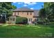 Lush backyard showcasing the home's screened porch and patio, surrounded by green grass and landscaping at 2541 Penngate Dr, Sherrills Ford, NC 28673