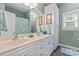 Bathroom featuring double sinks, storage cabinets, and window at 2541 Penngate Dr, Sherrills Ford, NC 28673